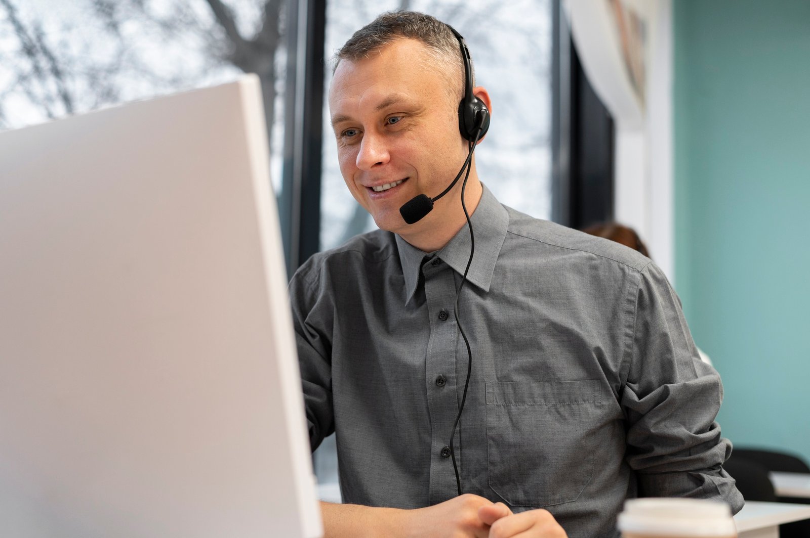 man-working-call-center-with-headphones-computer